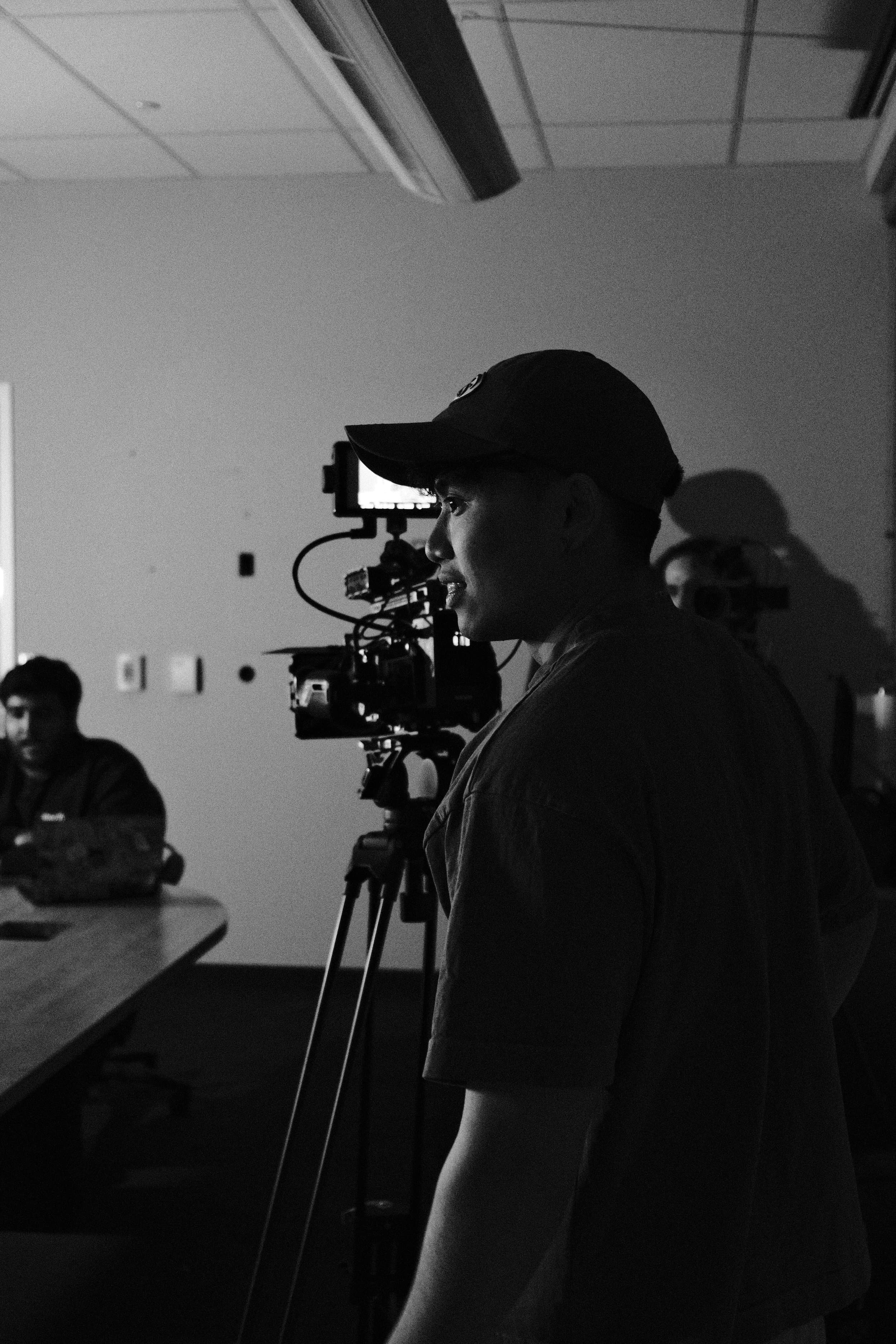 Camera operator in a cap during a production